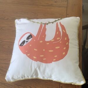 White Pillow with Orange Sloth Design